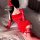 Woman in red velvet lingerie set with lace gloves and thigh-highs, styled as sensual sleepwear or costume outfit.