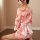 Retro japanese kimono lingerie set featuring a pink floral design, lace bodysuit with cut-out details, and a waist-cinching b...