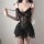 Woman wearing black lace sleepwear set with sheer mesh camisole and shorts, romantic princess-style sensual nightwear.