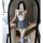 A woman poses in a mirror wearing a romantic school uniform-style jumpsuit with a bow tie, perfect for a cute and elegant loo...