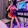A woman poses in front of a computer, wearing a red lace sleep dress inspired by vintage chinese styles. the dress features s...