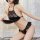 Woman wearing black royal lace belly dance chemise, strapless silk-look sleepwear with lace trim and halter neck detail.