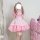 A woman models a charming pink s4xl maid costume cosplay dress, featuring ruffled details and a voluminous skirt, perfect for...