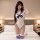 Woman in white sailor cosplay bodysuit with blue trim, deep v-neck, bow, open-crotch design, and striped thigh-high socks on ...
