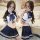 Woman modeling sexy sailor uniform role play costume set with crop top, bow tie, and pleated skirt for cosplay and adult game...