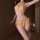 Woman modeling yellow sakura passion lingerie set, sheer wet-look bikini with bow details for bedtime seduction.