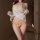 Woman wearing yellow sakura passion lingerie set with sheer white cover-up, featuring wet-look bikini and bow details for bed...