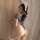 Woman wearing sanshengyin sensual lace bodysuit with open-crotch design, bunny ears headband, and thigh-high stockings.