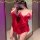 Woman wearing red satin sleep dress with ties, posing in front of mirror. alluring summer lingerie nightgown for women.