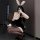 Woman in black secretary bunny girl lingerie set with lace gloves, ears, and heels posing seductively for role play.