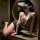 Woman posing in leopard print bustier bodysuit with deep neckline and black shorts, styled as sultry lingerie set.