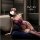 Woman in purple lace lingerie set with garters, sitting by bathtub – seductive style for small bust & roleplay.