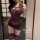 Woman in purple lace-trimmed sleepwear set, featuring sheer mesh and thigh-high stockings — seductive style for romantic ni...