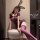 Woman in purple seductive style sleepwear set with lace bunny ears, posing seductively on ottoman — romantic lounge outfit ...