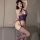 Woman wearing a purple sheer bodystocking with an open crotch and attached fishnet stockings.