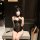 Woman wearing black lace bunny bodysuit with push-up cups, ears, and open-crotch design — seductive adult playwear.