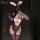Woman in black lace bunny girl bodysuit with pink bow, ears, and sheer gloves—provocative luxury sleepwear set.