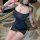 Woman wearing black sheer mesh cheongsam lingerie with cut-out details and lace trim, styled for romantic couples play.