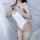 Woman modeling white backless bodysuit swimwear with low-cut front and no-remove design, showcasing sleek japanese-style silh...