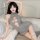 Woman wearing gray seductive knit sweater with open chest lace-up detail, sheer high-neck bodysuit for date night.