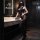 Woman in black lace bodysuit with open-crotch stockings, posing in modern bathroom. seductive lingerie set for small bust.