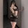 Woman wearing black lace bodysuit with open-crotch design, sheer panels, and floral detailing — sensual sleepwear set for int...