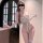Woman in white sheer lace bodysuit with cut-outs, holding wine glass; seductive lace bodysuit from pure allure collection.