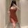 A woman takes a mirror selfie wearing a seductive lace slip dress paired with a matching bralette, holding a glass of wine. t...