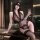 Woman in black lace lingerie set with sheer bodysuit, removable cups, and stockings, holding wine glass.