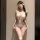 Woman wearing white lace lingerie set with sheer bodysuit, garter stockings and blindfold. seductive sleepwear with removable...