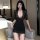Woman wearing a black lace ol secretary skirt set with a deep v-neck and sheer sleeves, perfect for nightclub outings.