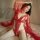 Woman wearing red lace open-crotch bodysuit with sheer cutouts, part of busty lingerie set featuring no-remove design.
