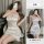 Woman modeling white satin lace sleep dress, sheer thin lingerie with delicate trim for intimate date night wear.
