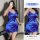 Woman wearing blue satin lace sleep dress, holding wine glass, elegant lingerie for date night.
