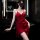 Woman in red satin cami dress with waist tie, posing in modern bathroom. elegant sleepwear for curvy figures.