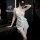 Woman in elegant white satin cami dress with wrap tie, posing in modern bathroom – seductive lace sleepwear for women