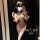 Woman wearing seductive leopard print lingerie set with fluffy cat ears and white thigh-high stockings, capturing a mirror se...