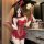 Woman in red bunny girl lingerie set with open-crotch design, holding feather wand—pure & tempting sleepwear.