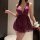 Woman wearing a seductive purple lace lingerie set with deep v-neck and sheer skirt, styled as playful sleepwear.