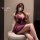 Woman wearing seductive purple lingerie set with lace details, styled as playful sleepwear or naughty outfit.