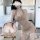 Woman wearing a beige ribbed halter mini dress, styled as seductive lingerie and sexy sleepwear for couples.