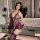 Woman in purple lace maid lingerie set with garter stockings, posing in modern bathroom.