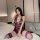 Woman wearing a purple lace maid costume lingerie set, featuring a deep v-neck bodysuit with garter straps and sheer stocking...