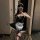Woman in a seductive maid costume lingerie set, featuring a black dress with white lace trim and apron, paired with fishnet s...