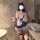 Woman wearing seductive maid costume set with lace, tulle dress, apron, cat ears headband, and fishnet stockings in bathroom.