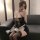 Woman wearing black sheer mesh maid lingerie with tear-away chest and open-crotch design, paired with lace stockings and glov...
