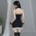 Woman in black strapless dress with lace trim and sheer stockings, styled as a seductive air hostess boudoir outfit.