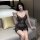 Woman in seductive v-neck sheer lace nightgown, shiny bodycon slip dress with sparkling details, elegant lingerie sleepwear.