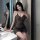 Woman wearing a seductive v-neck sheer lace nightgown, shiny bodycon slip dress, posing elegantly by a mirror.