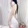 Woman in white seductive open-front backless knit set, featuring a provocative lingerie dress and matching sleepwear outfit.